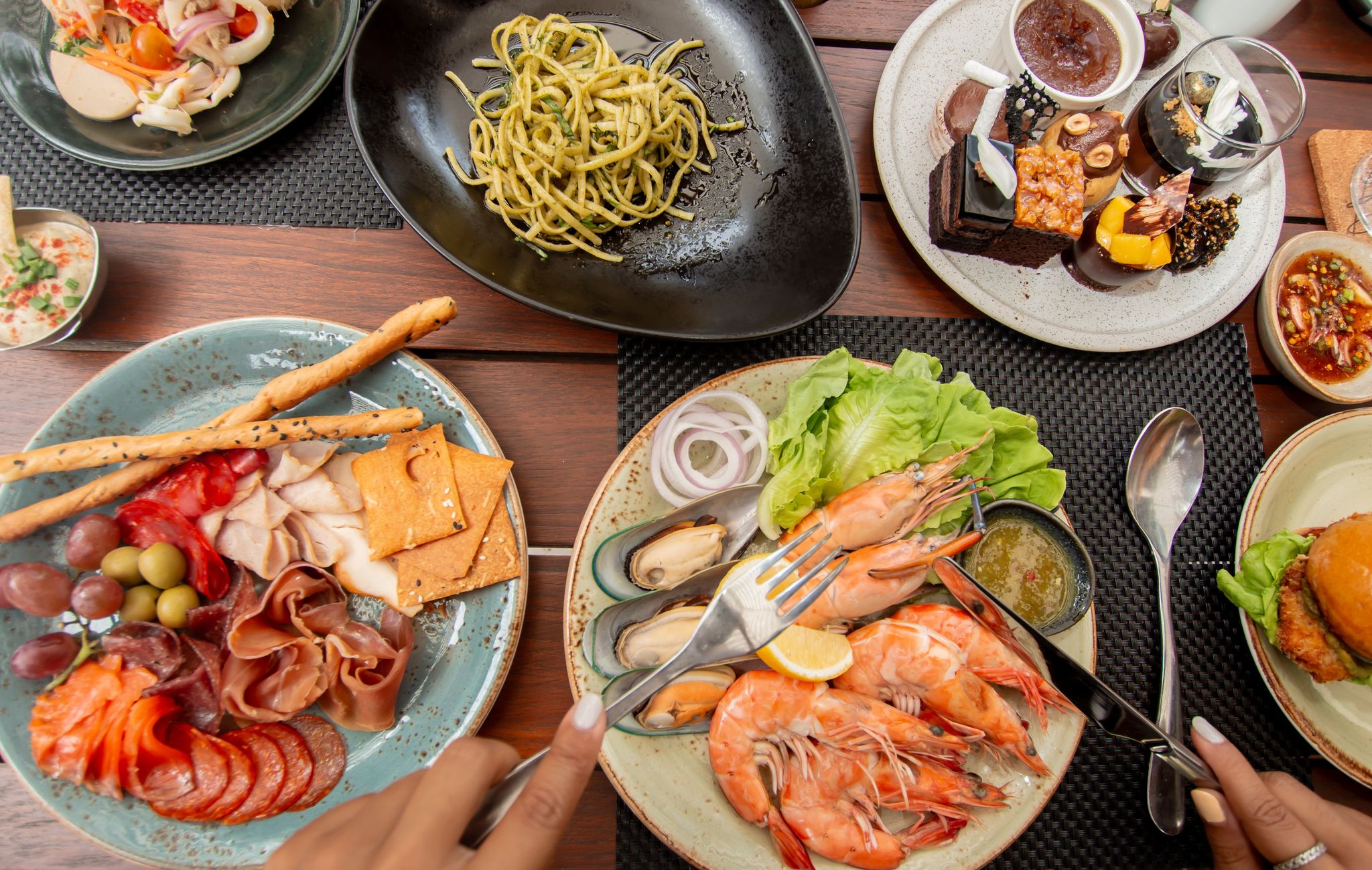 A table full of plates with food on them.