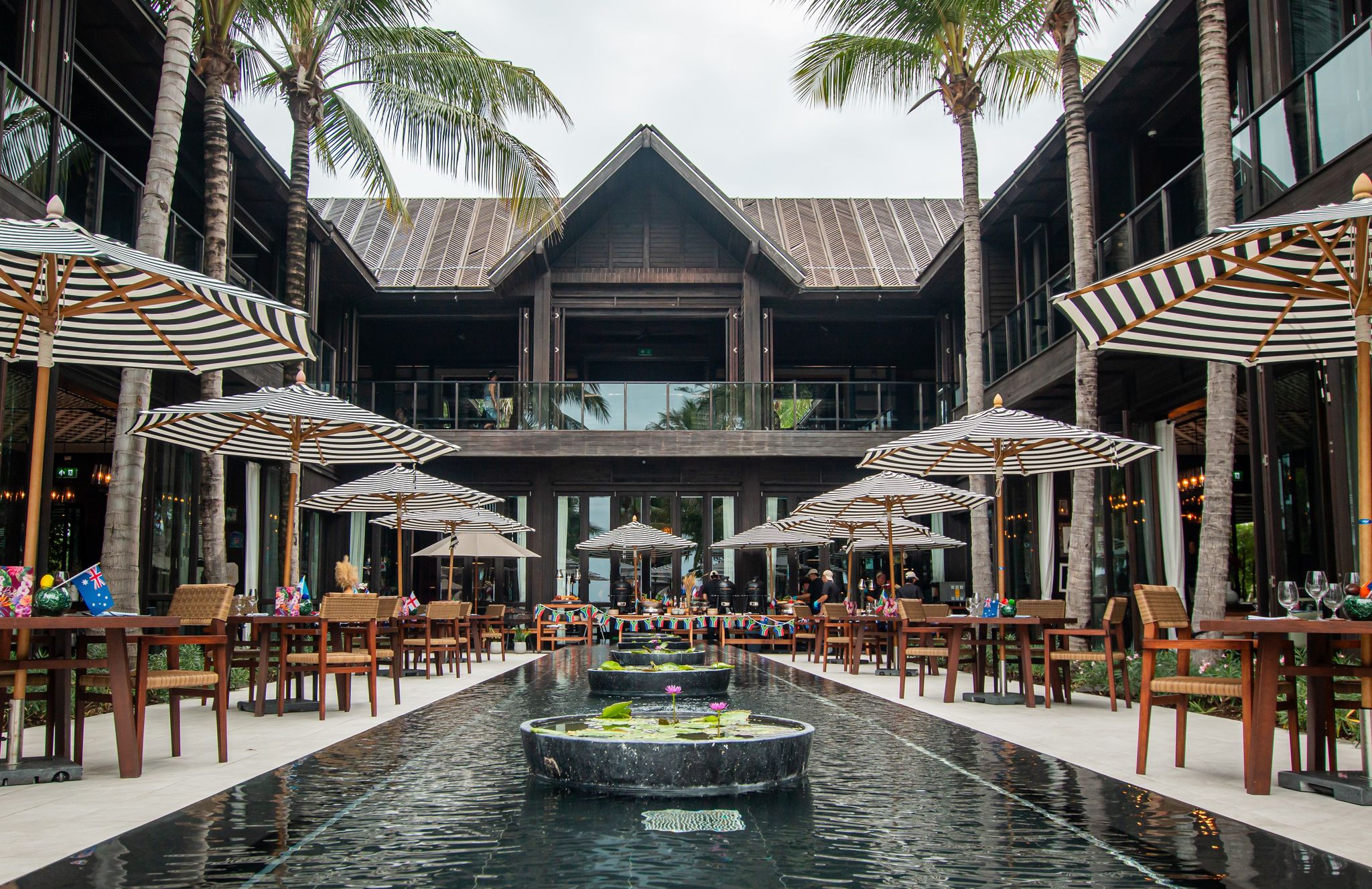 An outdoor dining area with tables and umbrellas.